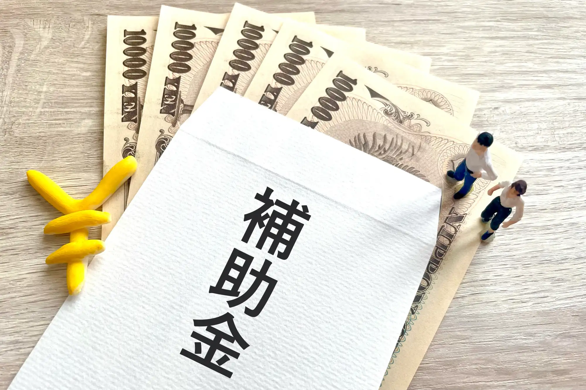 補助金と書かれた封筒から札束が少し出ている
